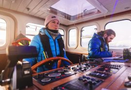 Guest on board Valiente at helm sailing
