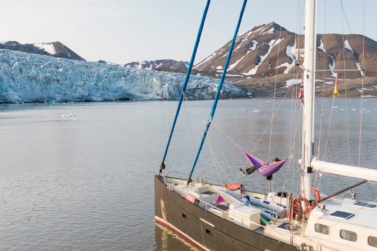 Guest relaxing in hammock on board Valiente summer Svalbard