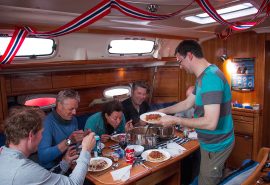Guests eating on board Humla saloon interior