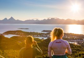 Guests hiking in summer sunshine Lofoten islands Norway