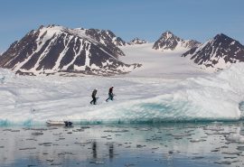Guests hiking on fjord in Arctic Svalbard Valiente