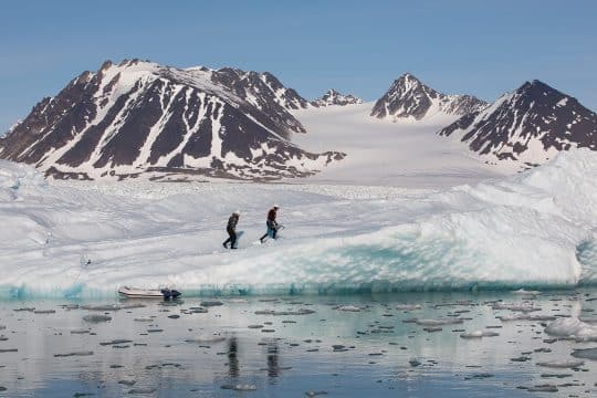 Guests hiking on fjord in Arctic Svalbard Valiente