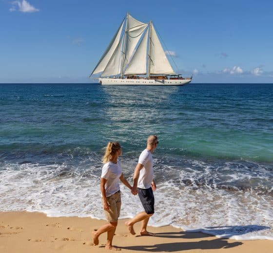 Guests on beach with Chronos in background Caribbean