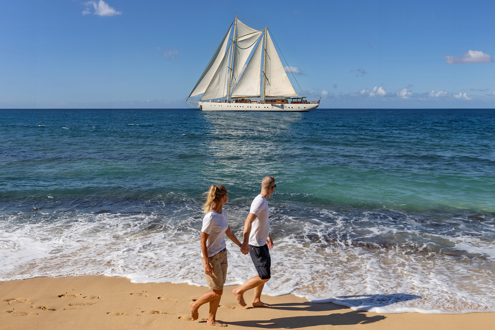 Guests on beach with Chronos in background Caribbean