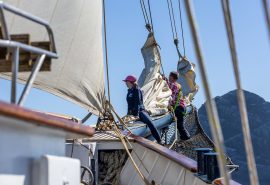 Guests on bowsprit of Blue Clipper