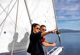 Guests on bowsprit of yacht Kairos