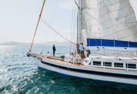 Guests on deck of expedition yacht Zuza underway