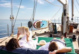 Guests reading and relaxing on deck of Kairos