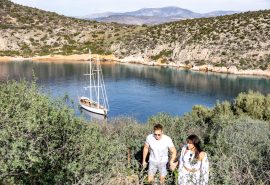 Guests walking ashore with Kairos anchored in bay Greece