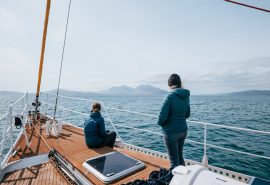 Guests watching scenery on deck of Zuza