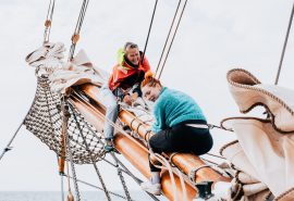 Happy guests on bowsprit of Aron
