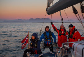Humla group of guests sailing at sunset in Norway winter