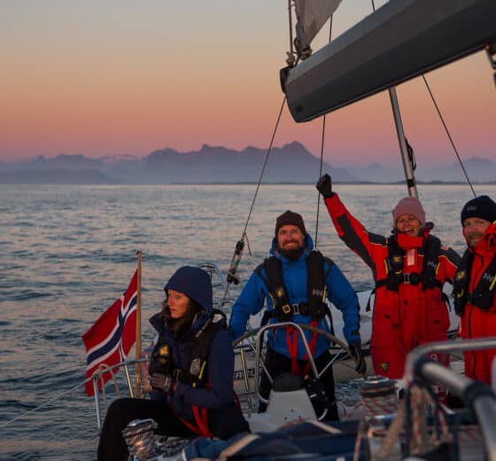 Humla group of guests sailing at sunset in Norway winter