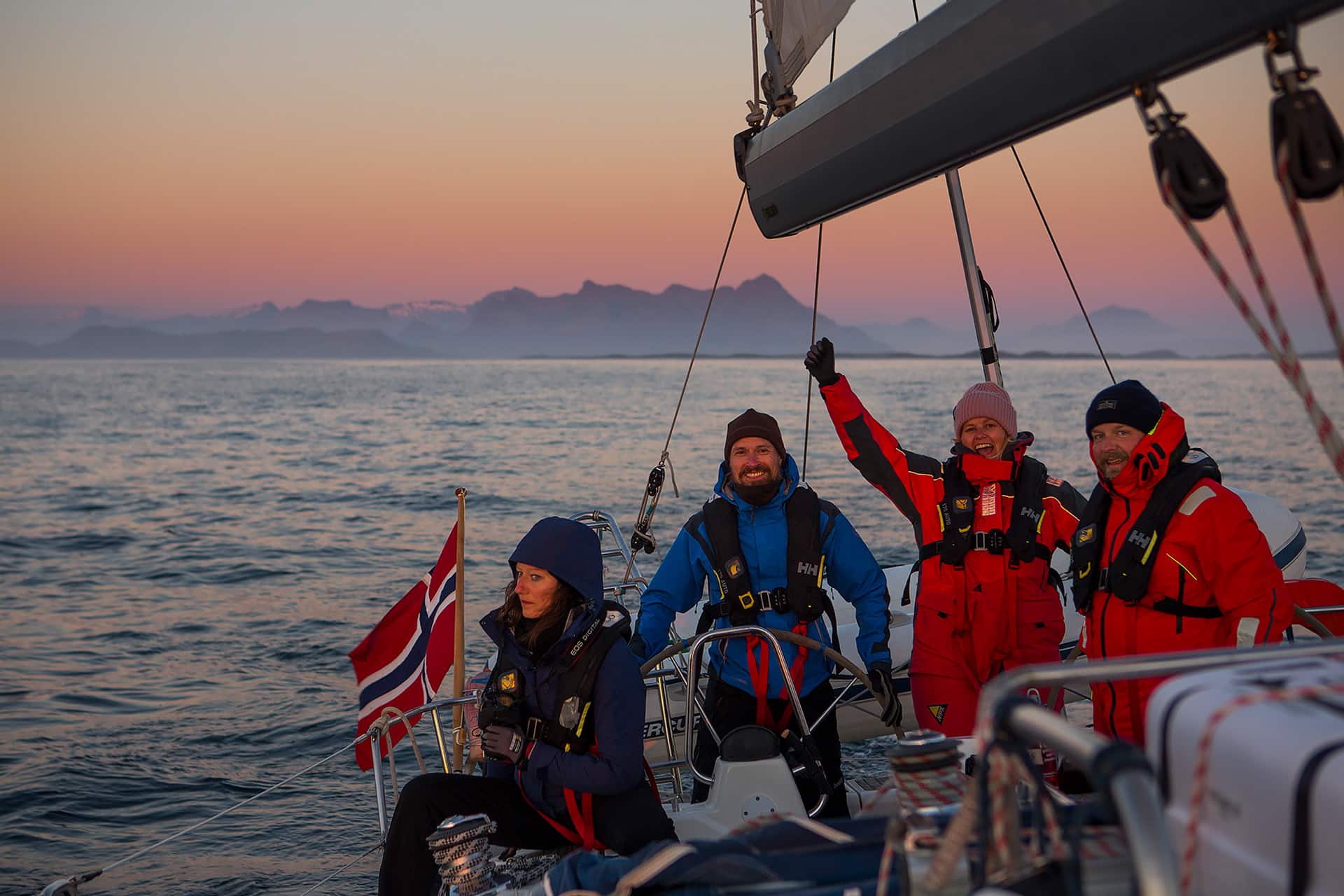 Humla group of guests sailing at sunset in Norway winter