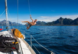 Humla guest jumping off boat summer Norway lofoten islands
