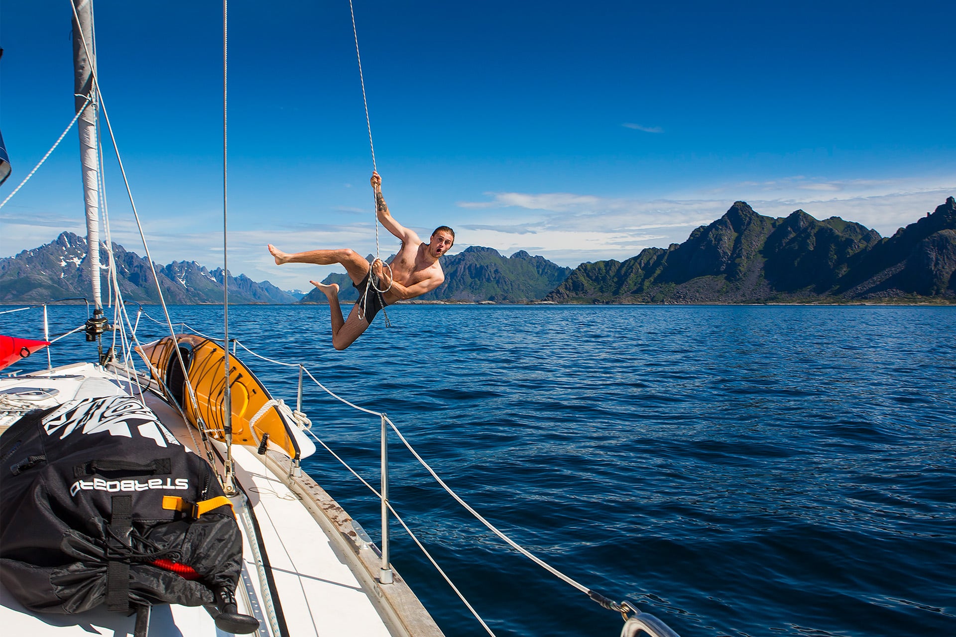 Humla guest jumping off boat summer Norway lofoten islands