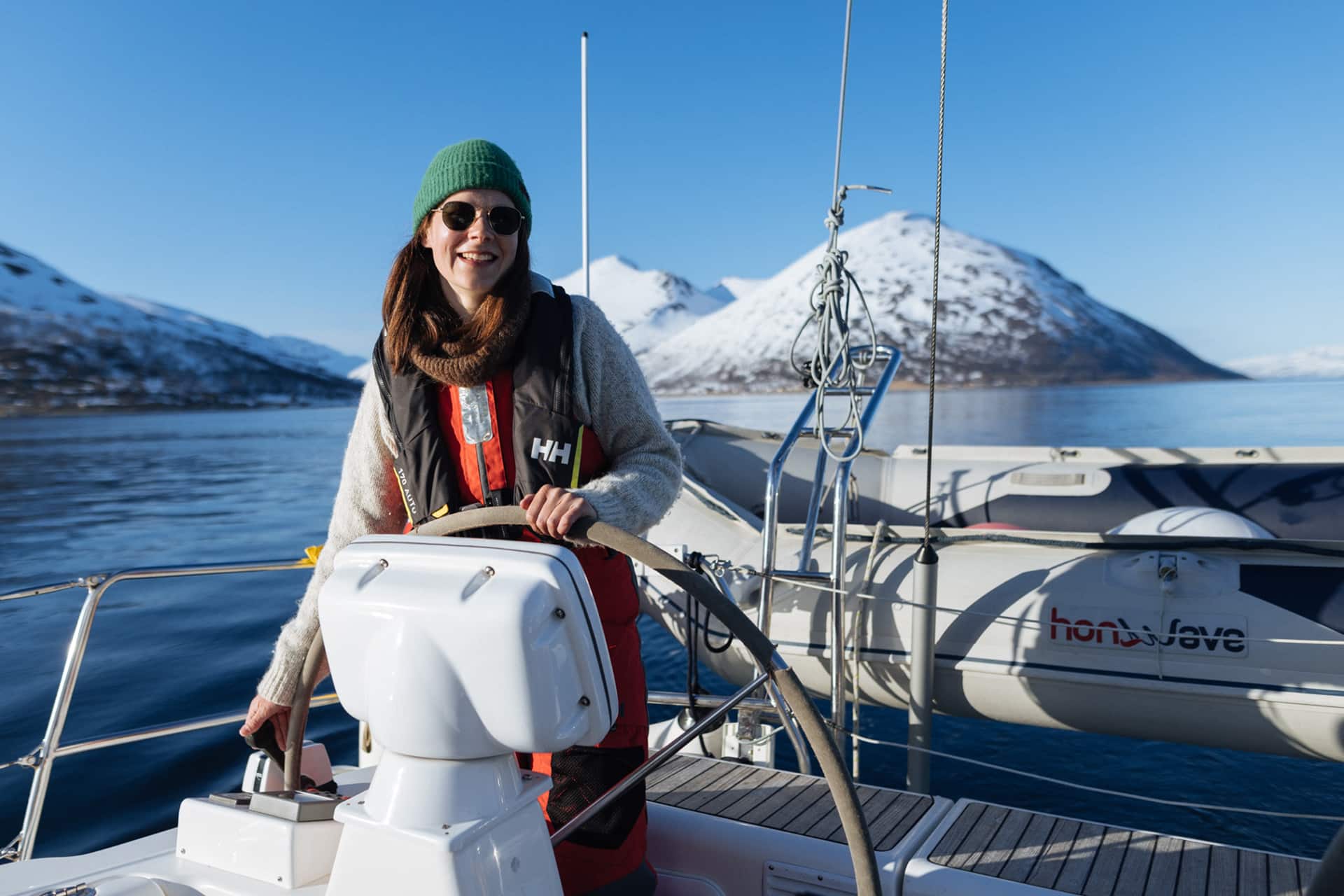 Humla guest onboard at helm in Northern Norway winter sailing