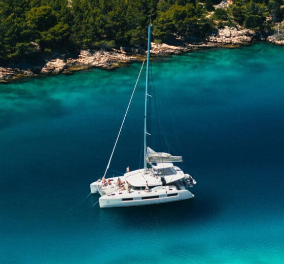 Ingrid More catamaran anchored in turquoise cover