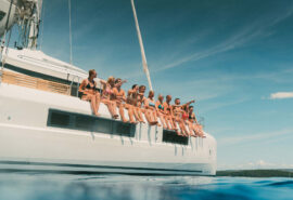 Ingrid More catamaran guests on deck of catamaran anchored