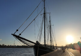 Iris tall ship alongside sunset baltic sea