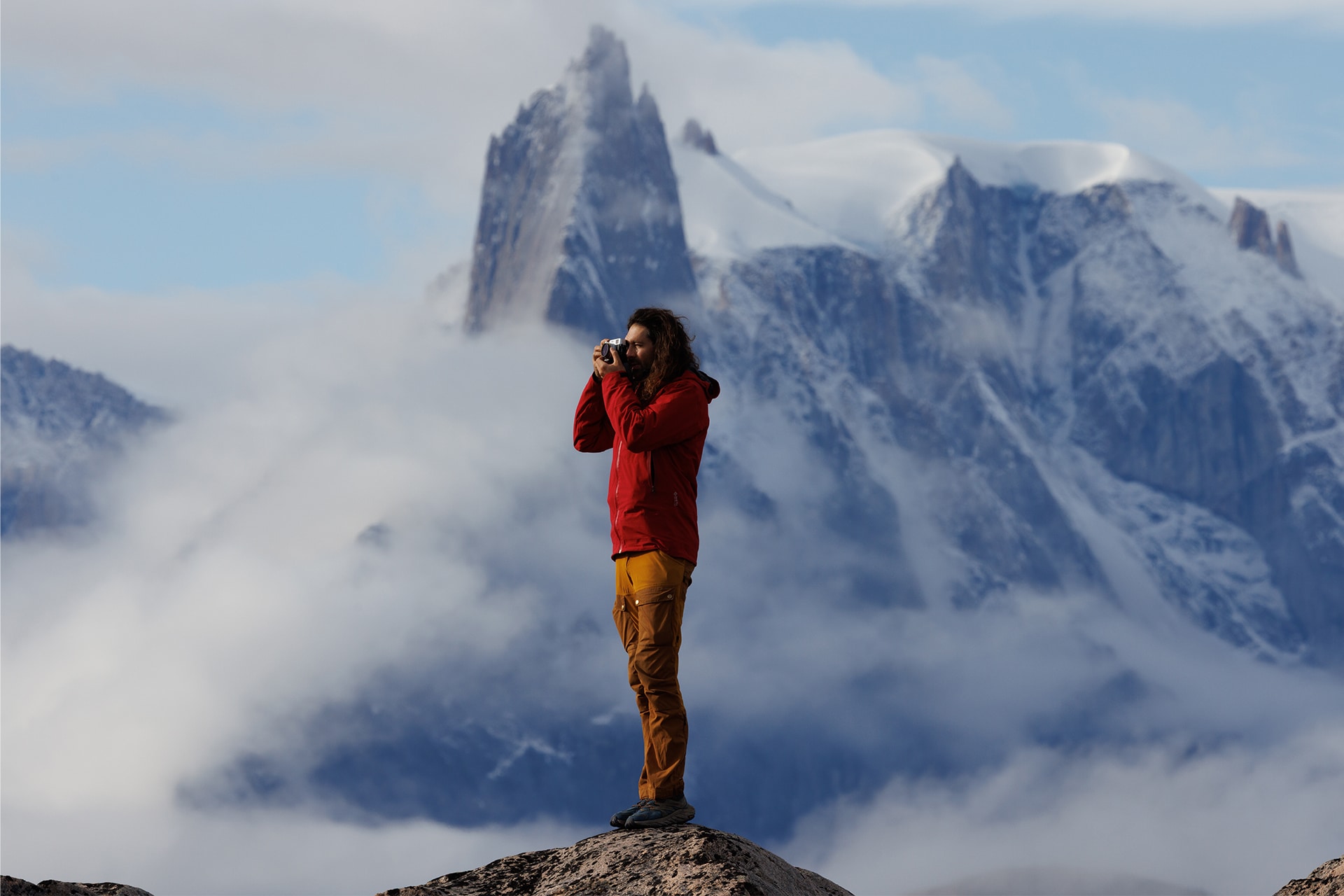 Linden guest standing on mountain Arctic Greenland views
