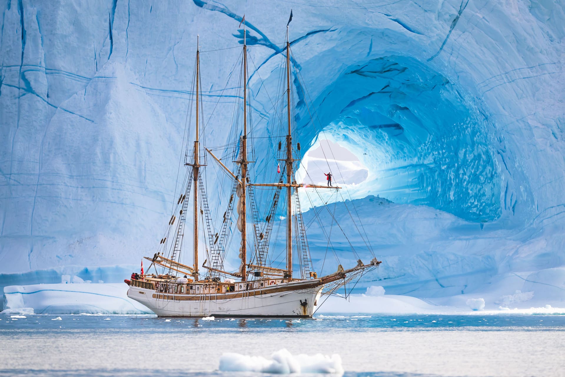 Linden tall ship anchored beneath glacier in Greenland Arctic Circle sailing