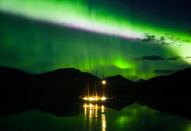 Linden tall ship anchored under Northern lights in the Arctic Circle Greenland