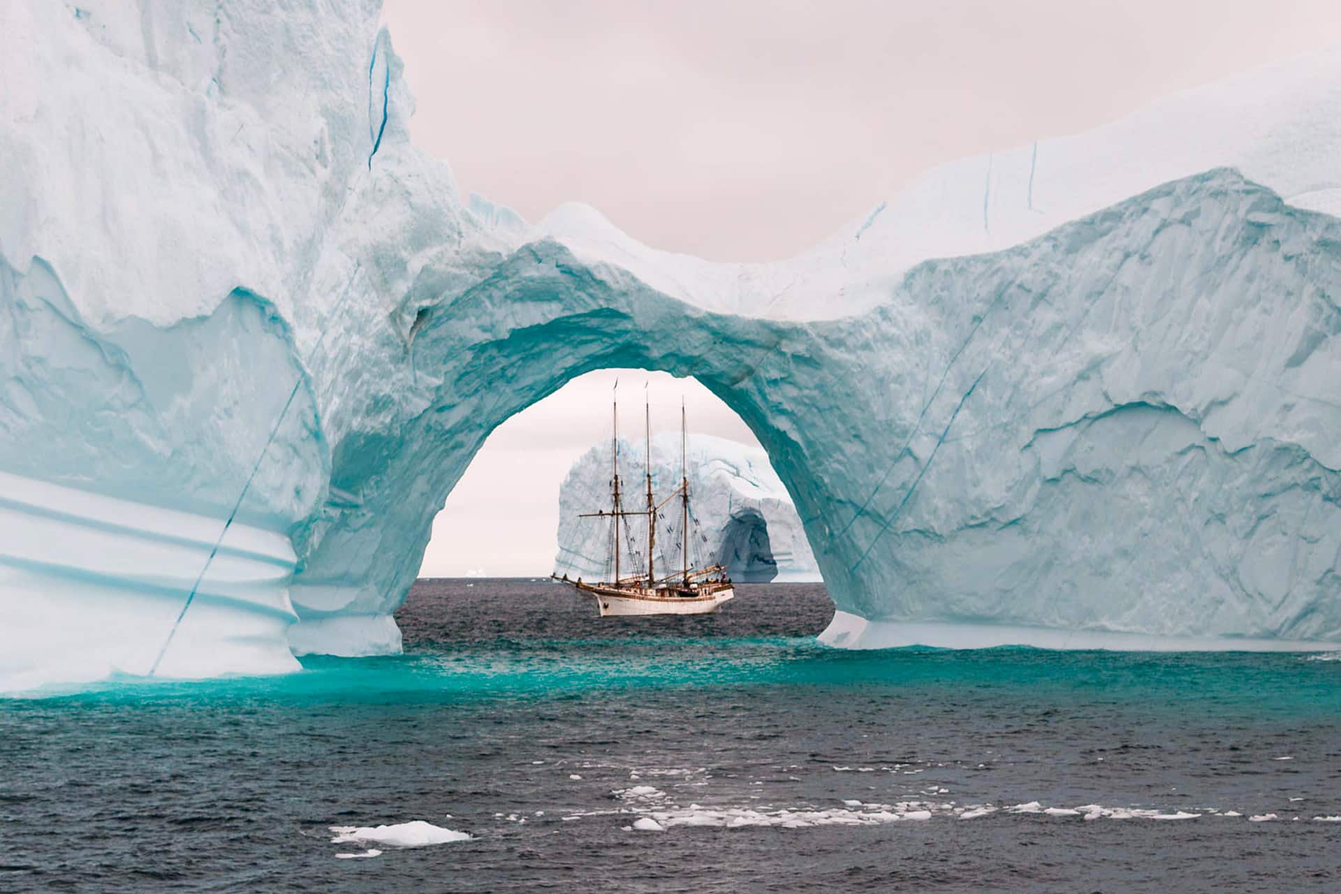 Linden tall ship beneath glacier iceberg arctic circle sailing Greenland