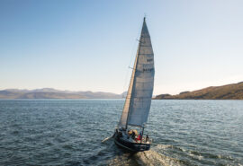 Noonmark VI adventure yacht sailing from stern Scotland