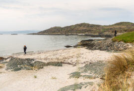 Noonmark VI guests walking on Scottish beach, Twin beaches, Isle of Gigha, Hebrides, Kintyre, Scotland