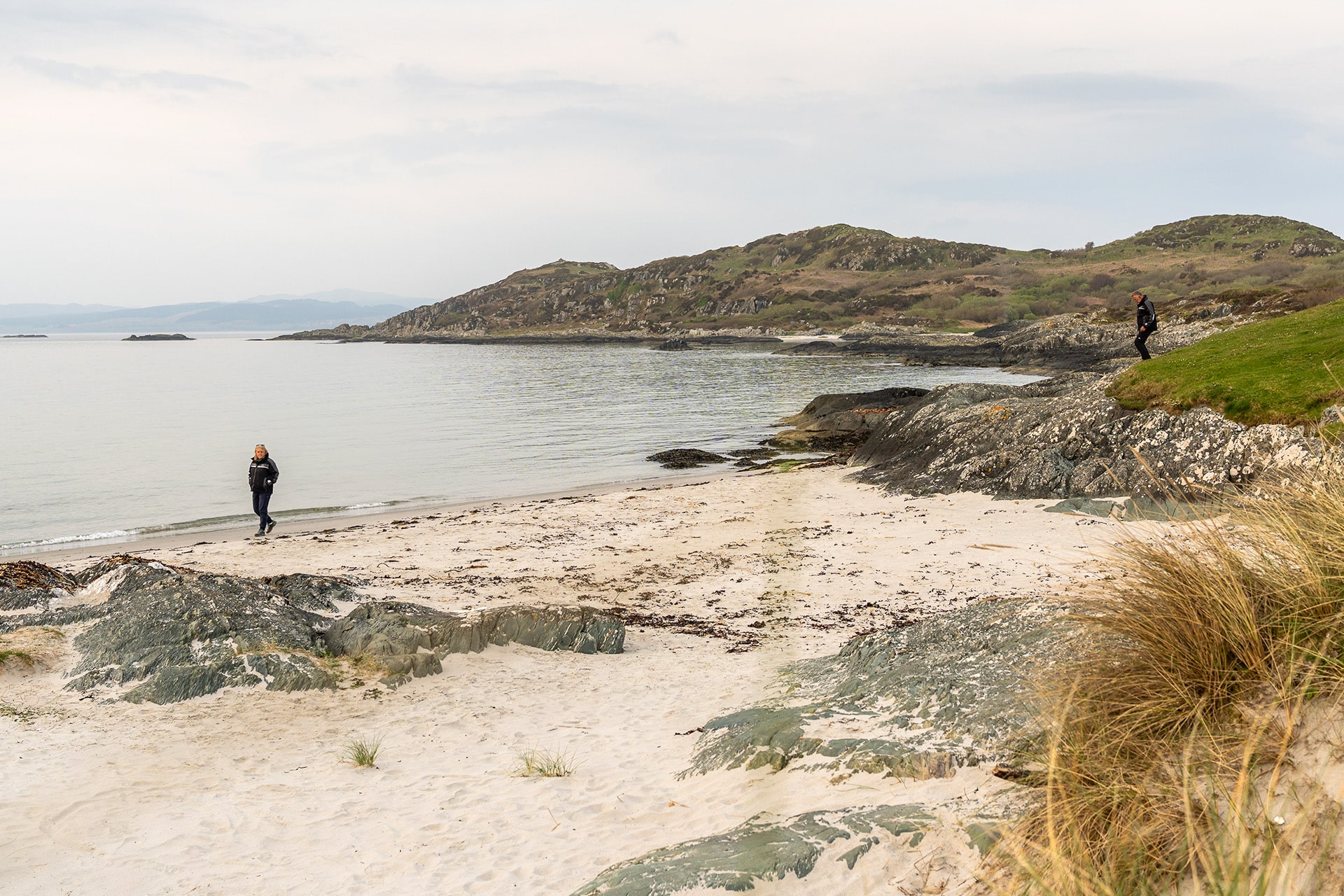 Noonmark VI guests walking on Scottish beach, Twin beaches, Isle of Gigha, Hebrides, Kintyre, Scotland