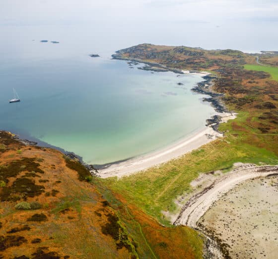 Noonmark VI yacht anchored aerial view at Twin beaches, Gigha, Kintyre, Hebrides Scotland