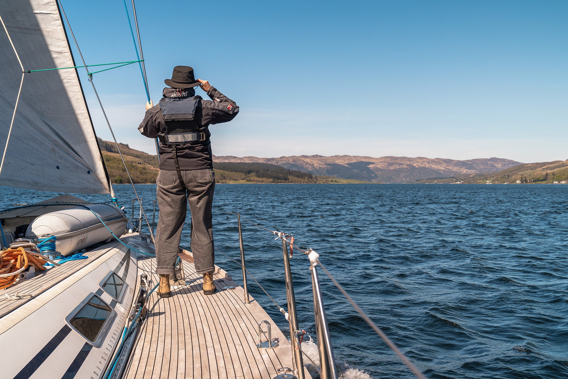 Noonmark VI yacht guest wildlife watching on deck in the Hebrides, Scotland