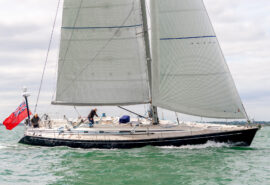 Noonmark VI yacht sailing underway in full sail from side