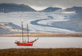 Noorderlicht anchored in Svalbard with arctic fjord summer