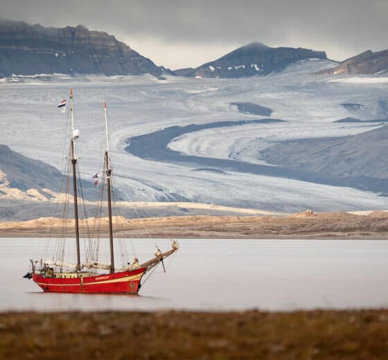 Noorderlicht anchored in Svalbard with arctic fjord summer