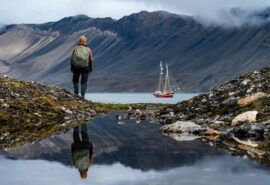 Noorderlicht anchored with guest hiking Svalbard Summer