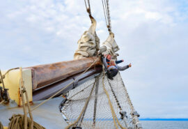 File name: Noorderlicht-guests-on-bowsprit-of-tall-ship.jpg