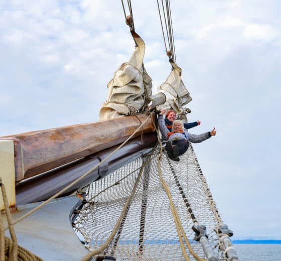 File name: Noorderlicht-guests-on-bowsprit-of-tall-ship.jpg