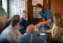 Noorderlicht guests onboard being served dinner