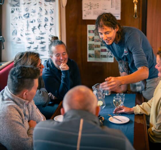 Noorderlicht guests onboard being served dinner