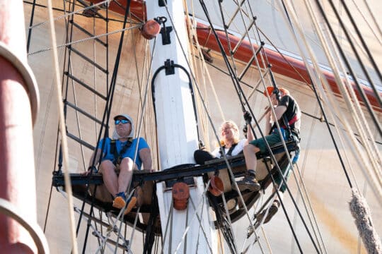 Oosterschelde guests onboard climbing rigging on deck