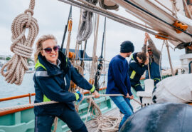 Pellew guests on deck pulling ropes