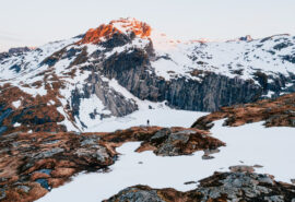 Person hiking in snowy Lofoten islands Norway
