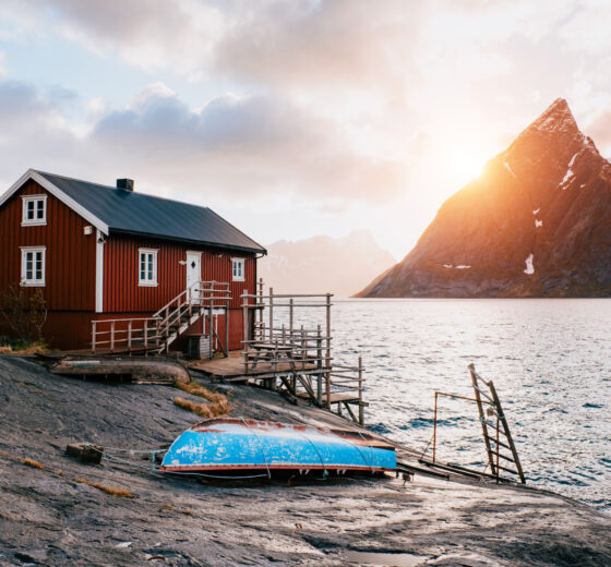 Red cabin on shoreline in Lofoten islands