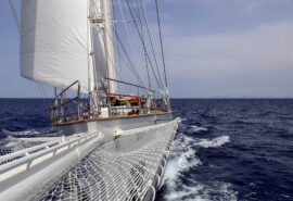Rhea classic yacht sailing underway offshore from bow