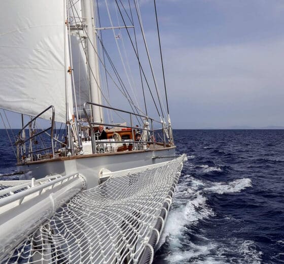 Rhea classic yacht sailing underway offshore from bow