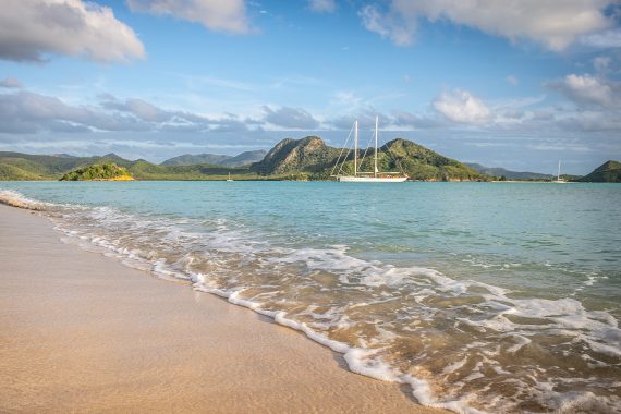 SC yacht anchored off Caribbean beach Chronos Rhea Kairos