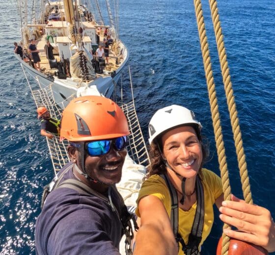 Santa Maria Manuela guests on bowsprit tall ship