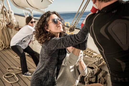 Santa maria manuela guests onboard pulling ropes tall ship